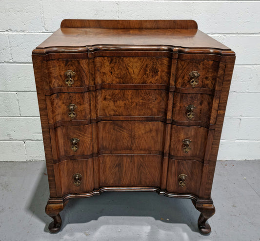 Antique English Figured Walnut inverted serpentine fronted chest of drawers. It is a great quality piece and is in good restored condition.