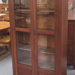Beautiful two door Blackwood bookcase with glass doors and with four fully adjustable shelves. It is in good original detailed condition.
