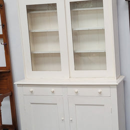 Australian painted two door kitchen hutch display and buffet cabinet. The top section has hooks and shelves. The bottom has two drawers along with cupboard space for added storage. In good original condition.