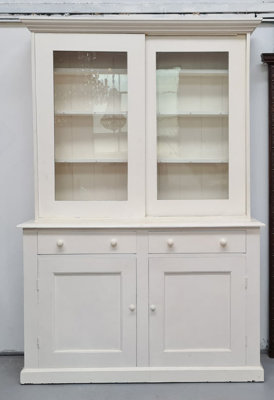 Australian painted two door kitchen hutch display and buffet cabinet. The top section has hooks and shelves. The bottom has two drawers along with cupboard space for added storage. In good original condition.