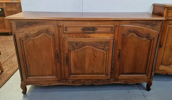 Lovely French Oak three-door sideboard with beautifully carved details and there is also a drawer. In good original detailed condition.