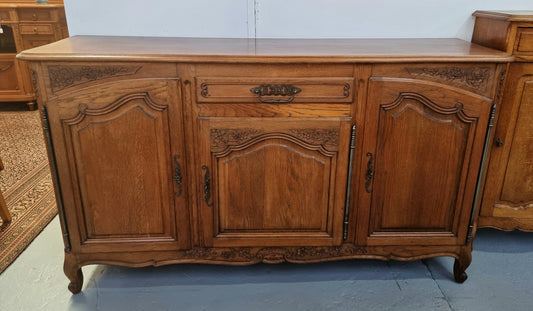 Lovely French Oak three-door sideboard with beautifully carved details and there is also a drawer. In good original detailed condition.