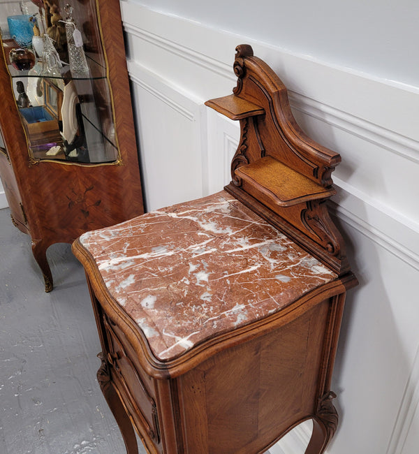 French Louis XV style Walnut single bedside cupboard with inset marble top. It has been sourced from France and is in good original detailed condition.