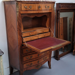 Walnut Louis XV style marble top abbattant with beautiful parquetry inlay and ormolu mounts. It has plenty of storage space with four large drawers and four smaller internal drawers. Beautiful drop down desk with a leather insert. In very good original detailed condition.