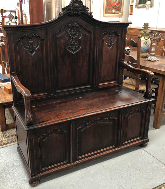 Beautifully carved French Oak hall seat with a lift up lid and storage space inside. In good original detailed condition.