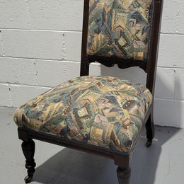 Single upholstered Edwardian nursing chair. Fabric is in good original used condition and chair has four caster wheels and is in good original condition.