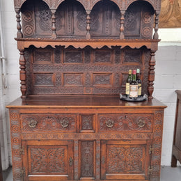 Impressively carved 18th Century English Oak kitchen dresser in 17th Century Jacobean style. It is in good original detailed condition and has been sourced from France.