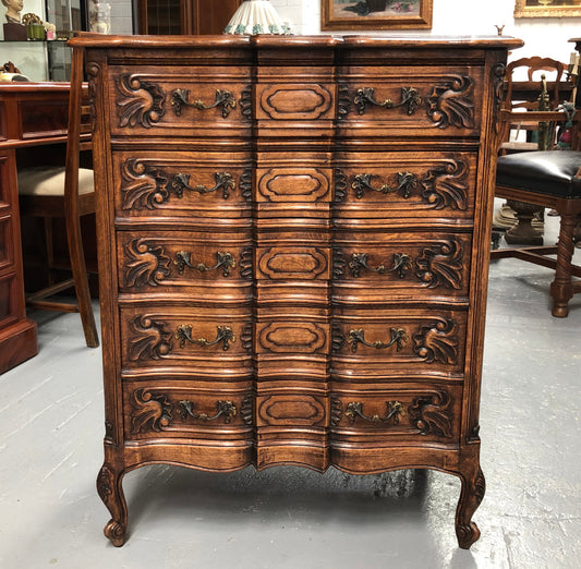 French Oak miniature chest of five drawers with serpentine shaped front. In very good original detailed condition.