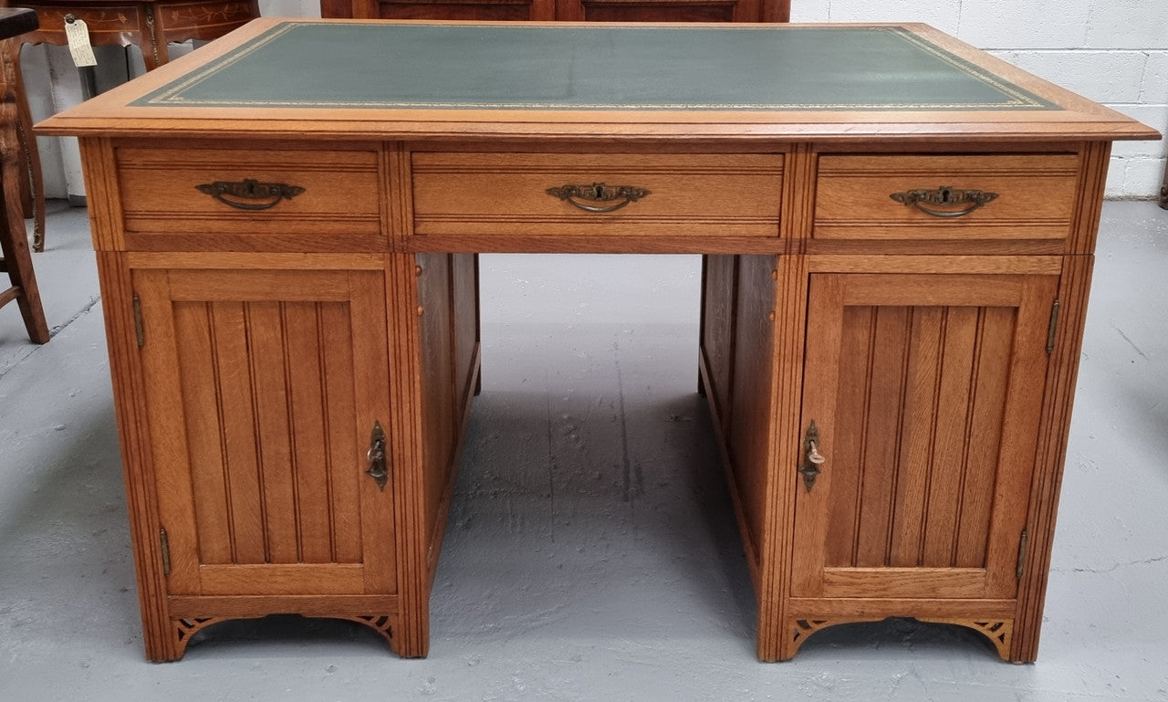 French Oak Art Deco full partners desk with leather top. Plenty of storage with both sides having three drawers at the top and two cupboards on both sides, one side has a filing section with three internal drawers and the other has a shelf on one side with three internal drawers as well. In good original detailed condition.