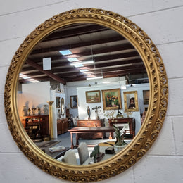 Decorative round gilt wall mirror.