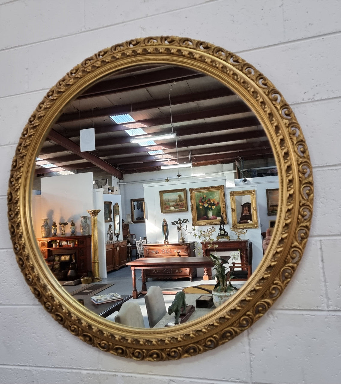 Decorative round gilt wall mirror.