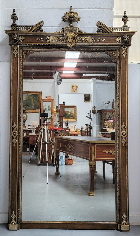 Early 19th Century French gilt and simulated wood mantel mirror. It still contains its original glass which contains loads of character. It is in very good detailed condition and has had minor restorations.