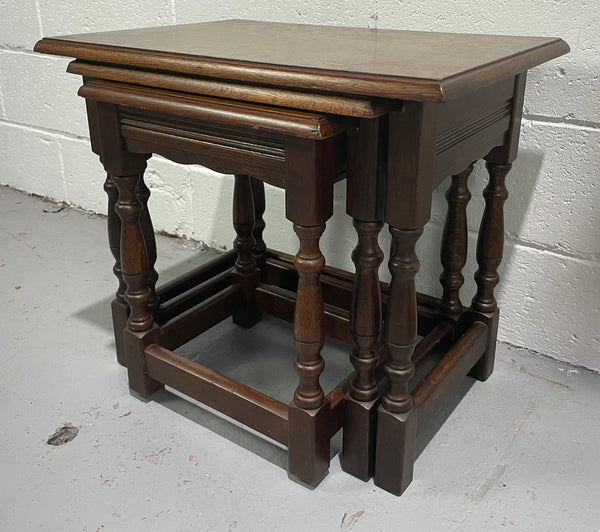 Tudor style English dark Oak nest of three tables. They are in good restored condition.