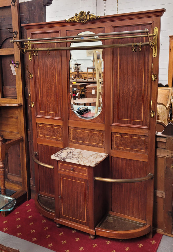 Attractive French Burr Walnut Hallstand. It has a single drawer, cupboard, brass rods, umbrella storage and a marble shelf. It is in good original condition. Please see photos as they form part of the description.