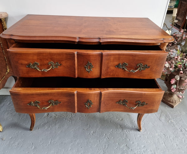 Elegant French Louis XV style Cherrywood commode with two drawers. It is in good original detailed condition.