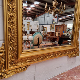 French ornate gilt framed wall mirror with bevelled mirror and decorated with water dragons. This has been sourced from France and is in good original condition.