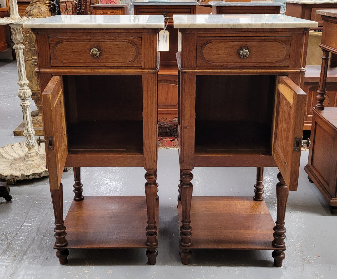 Antique French Oak Henry II white marble top bedside cabinets. They have one drawer and cupboard a long with an open shelf at the bottom. Sourced from France and in good original detailed condition.