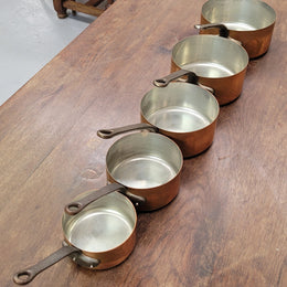 Set of five copper sauce pans with foundry stamp. They have been sourced from France and are in good original detailed condition.