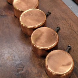 Set of five copper sauce pans with foundry stamp. They have been sourced from France and are in good original detailed condition.