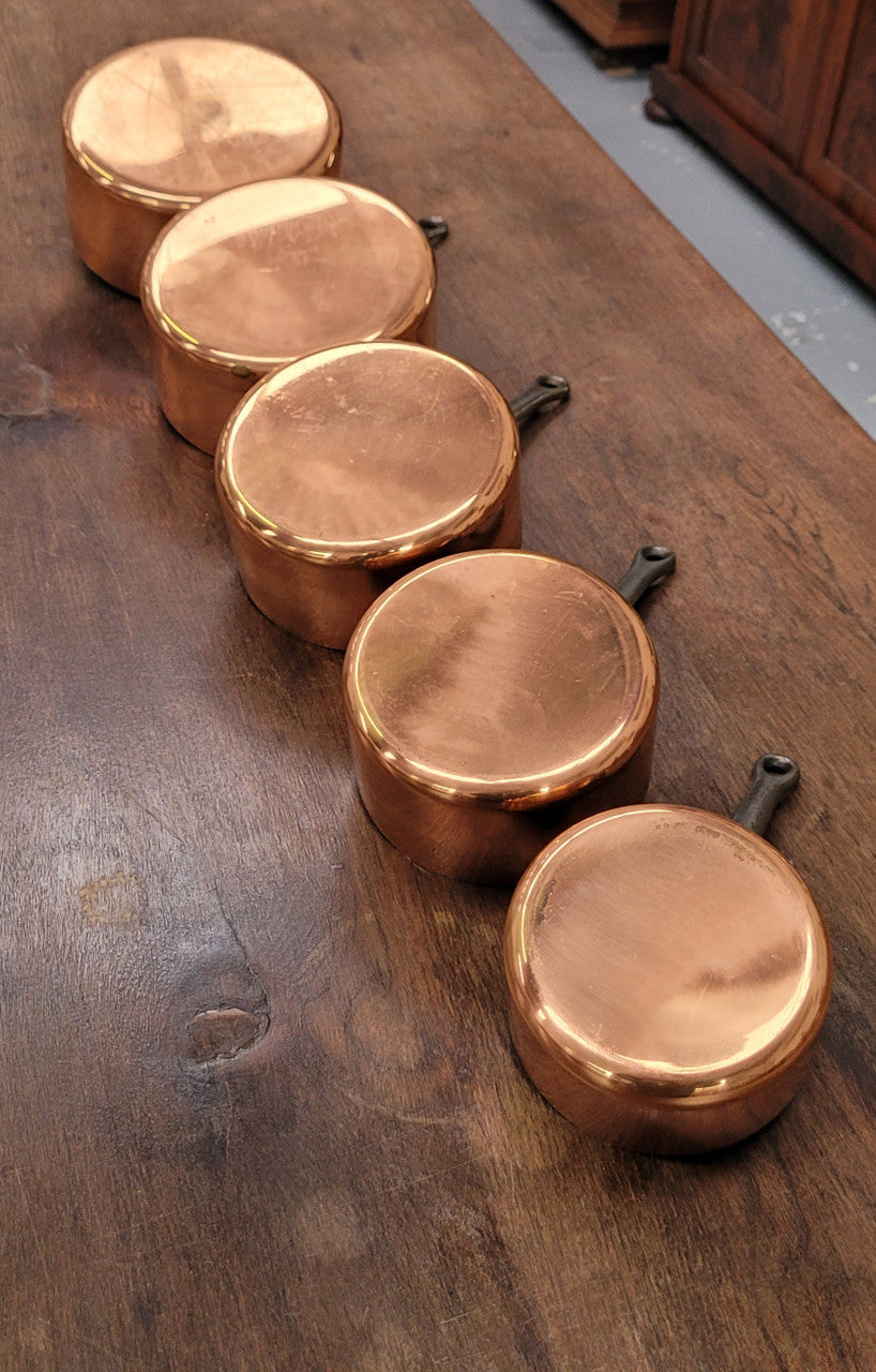 Set of five copper sauce pans with foundry stamp. They have been sourced from France and are in good original detailed condition.
