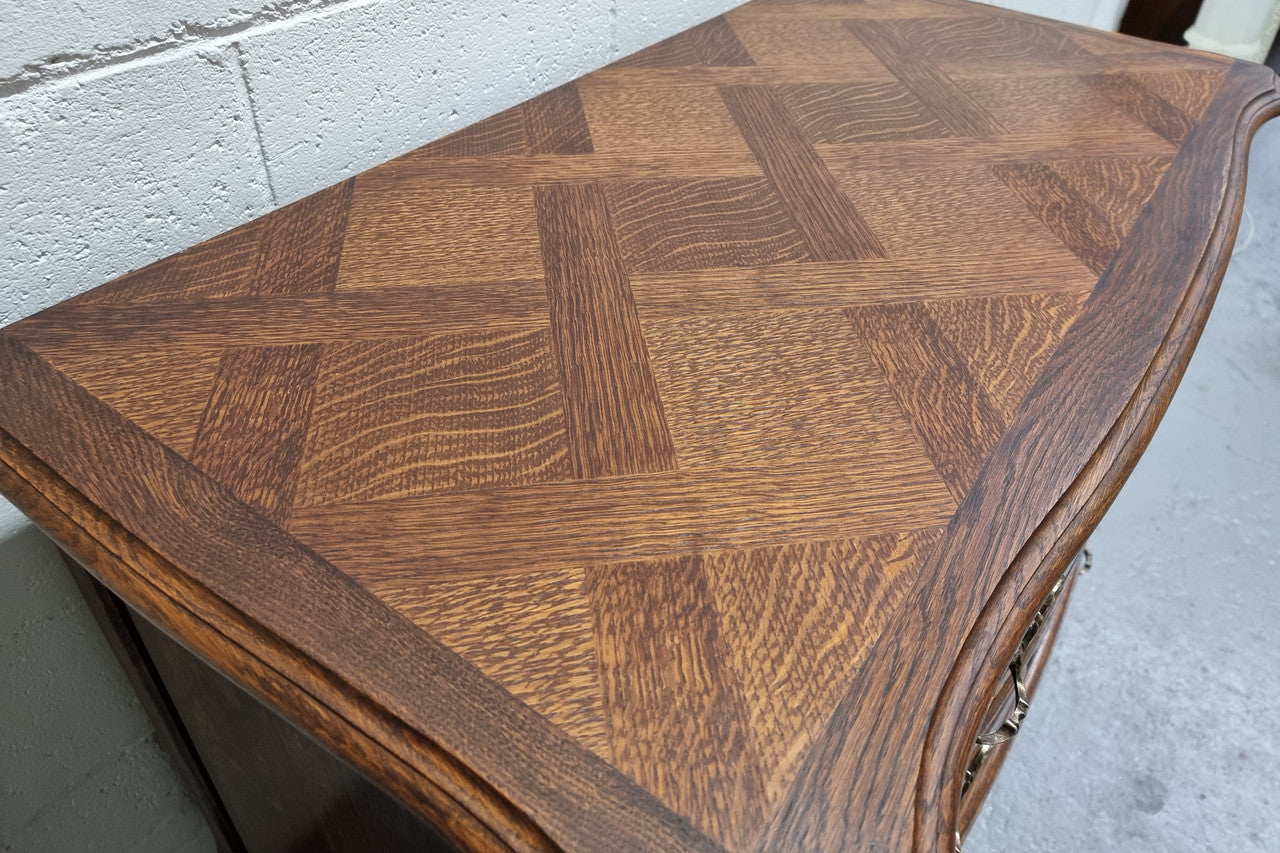 Lovely French nicely carved chest of 3 drawers with a parquetry top, with decorative handles and lovely carving. In good detailed condition.