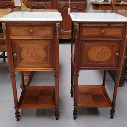 Pair of white marble topped Louis 16th style bedside cabinets consisting of one drawer and one cupboard.  Inlaid with burr walnut and has decorative mounts. They have been sourced from France and are in good original condition.
