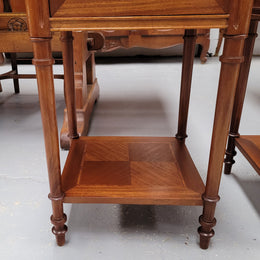 Pair of white marble topped Louis 16th style bedside cabinets consisting of one drawer and one cupboard.  Inlaid with burr walnut and has decorative mounts. They have been sourced from France and are in good original condition.