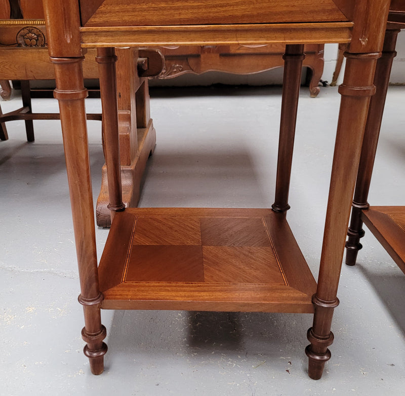 Pair of white marble topped Louis 16th style bedside cabinets consisting of one drawer and one cupboard.  Inlaid with burr walnut and has decorative mounts. They have been sourced from France and are in good original condition.