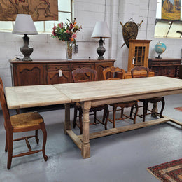 Beautilful raw solid oak French pedestal extension table. It has been sourced from France and is in good original detailed condition. When the table is fully extended it is 339 cm long and can comfortable seat 10-12 people. Features raw wood that could be used as is for a distressed look, or finished and waxed for a more refined look.