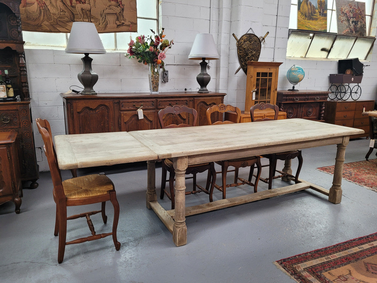 Beautilful raw solid oak French pedestal extension table. It has been sourced from France and is in good original detailed condition. When the table is fully extended it is 339 cm long and can comfortable seat 10-12 people. Features raw wood that could be used as is for a distressed look, or finished and waxed for a more refined look.