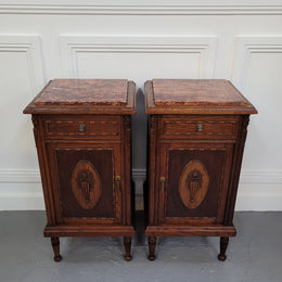 Pair of French Art Deco Oak and rouge inset marble top bedside cabinets. They have one drawer and one cupboard with elegant carving on the door. They have been sourced from France and are in good original detailed condition.