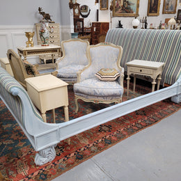 French chalk painted Louis XV style king size bed. Hard to find and newly upholstered in complimentary striped fabric. It has two small secret drawers at the back and stunning lion feet. It fits a king size mattress and base internally and custom slats could be made at request to accommodate a king size mattress, this would be an additional cost. It has been sourced from France and is in good original detailed condition.