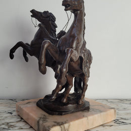 French Art Deco cold painted bronze metal marley horses style statue on a marble base. It is in good condition.
