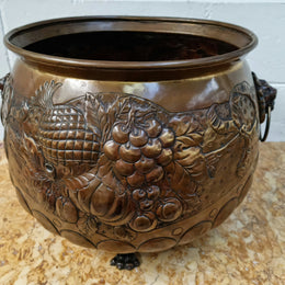 Antique large brass bronze coloured embossed Jardinière/planter with lovely details and lion heads for handles. It is in good original condition.