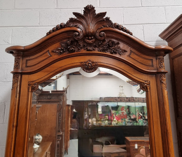 French single door Walnut Louis XV style armoire with mirrored door. In good orignal detailed condition.