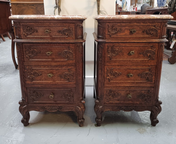 A pair of hard to find French Oak Louis XV style four drawer marble topped bedsides with attractive carvings. They are in good original detailed condition and have been sourced from France.