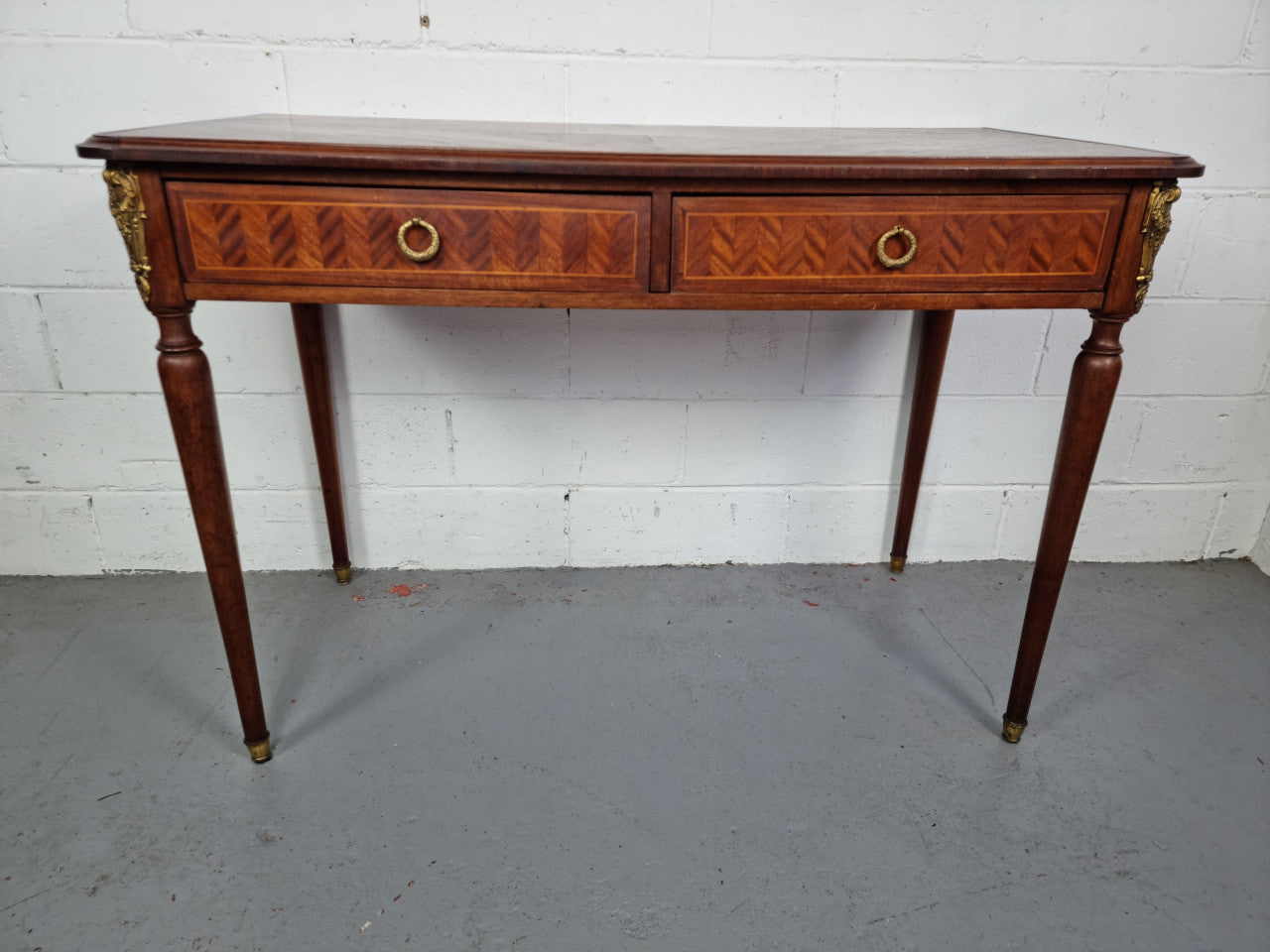 Lovely parquetry inlaid French late 19th Century Louis XV style desk. It has two drawers and decorative mounts and handles. In good original detailed condition.
