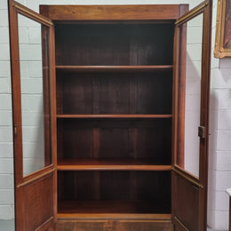 Grand French Mahogany Empire two door bookcase. It has beautiful glass doors and has three fully adjustable shelves. It has been sourced from France and is in good original detailed condition.