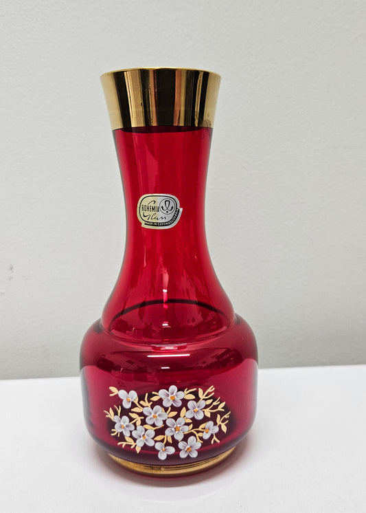 Lovely Bohemian ruby red glass vase with hand painted flowers and a guilt trimmings. It is in good original condition. Please see photos as they form part of the description.