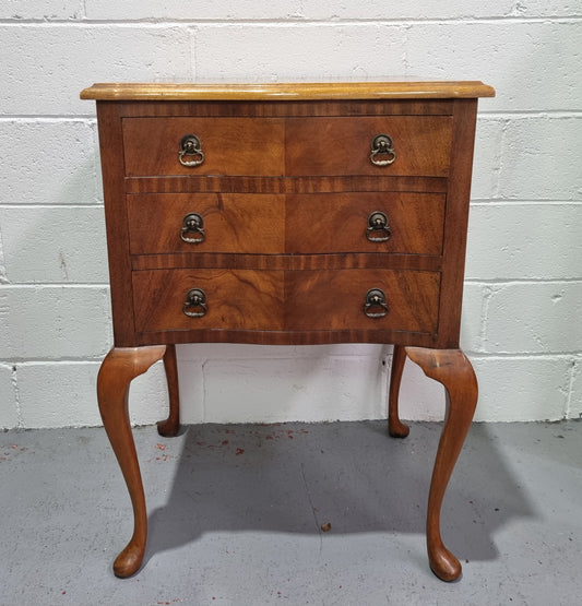 Antique Queen Anne style figured Walnut Bedside cabinet with 3 drawers. It is in good original detailed condition.