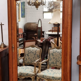 French Louis XV style Walnut armoire with single bevelled mirrored door. It has four adjustable shelves and a hidden exterior drawer at the bottom. It has been sourced from France and is in good original detailed condition.