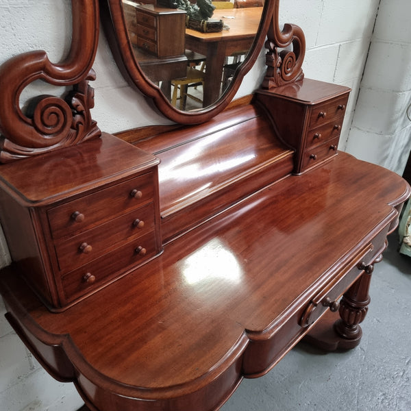 Victorian Mahogany duchess dressing table with tilt mirror on scrolled supports. It has seven trinket drawers and lift up storage. It is in good original condition and has been sourced locally.