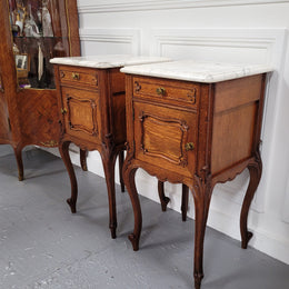 Pair of French Antique Louis XV style Oak marble top night stands. They have beautiful carved cabriole legs and beautiful white marble along with a drawer and cupboard for storage space. They have been sourced from France and are in good original detailed condition.