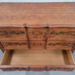 Vintage French dark Oak Louis XV style chest of three drawers. It has beautiful cabriole legs, elegant brass handles and decorative carving throughout. It is in good original detailed condition and has been sourced from France.