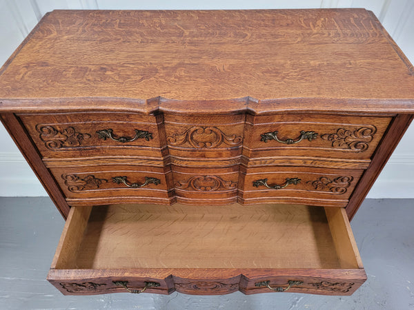 Vintage French dark Oak Louis XV style chest of three drawers. It has beautiful cabriole legs, elegant brass handles and decorative carving throughout. It is in good original detailed condition and has been sourced from France.