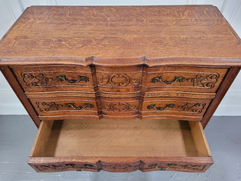 Vintage French dark Oak Louis XV style chest of three drawers. It has beautiful cabriole legs, elegant brass handles and decorative carving throughout. It is in good original detailed condition and has been sourced from France.