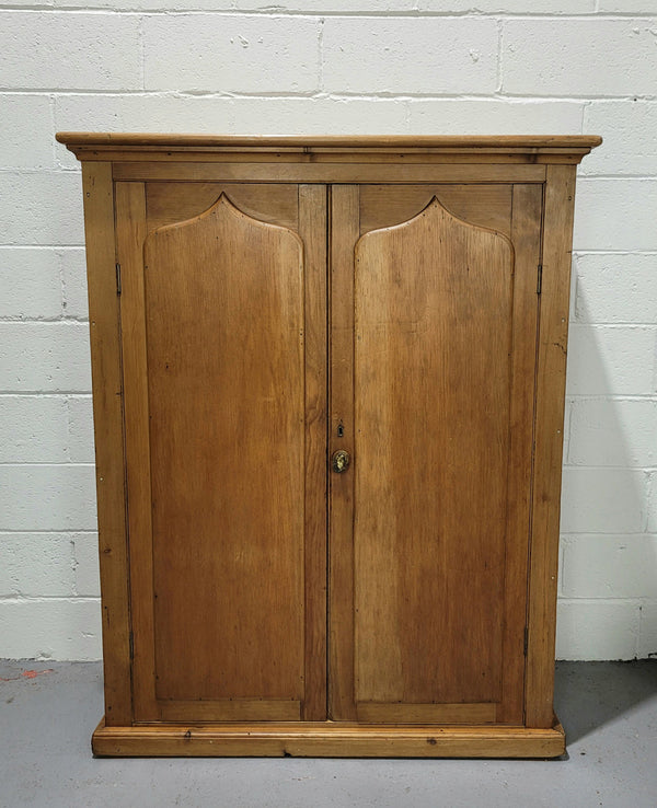 A lovely Victorian Pine shield cupboard with two doors and four shelves in good original detailed condition.