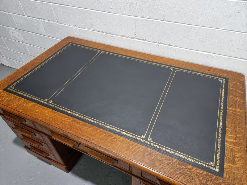 Amazing American Oak full partners leather top desk. Plenty of storage space with nine drawers on one side and two cupboards of the oppsite side. It is in good restored condition and has a new leather and gold tooled inset top.