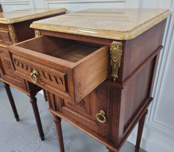 French Oak pair of Louis 16th style marble top bedsides with stunning bronze mounts. They have been sourced from France and are in good original detailed condition.