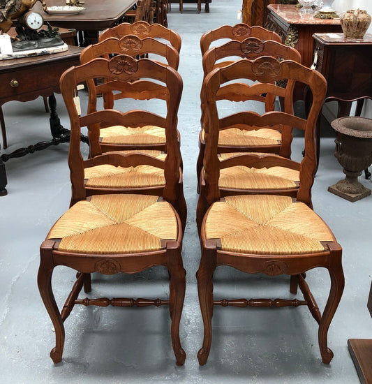 Antique set of six French Cherrywood rush seat dining chairs. In good original detailed condition.